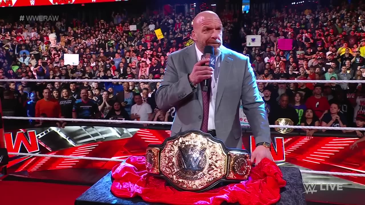 Triple H reveals new wwe world heavyweight chmpion belt in raw