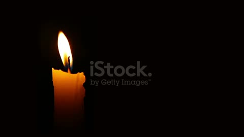 Moving single lit candle.