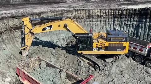 Caterpillar 374D excavator loading and man truck