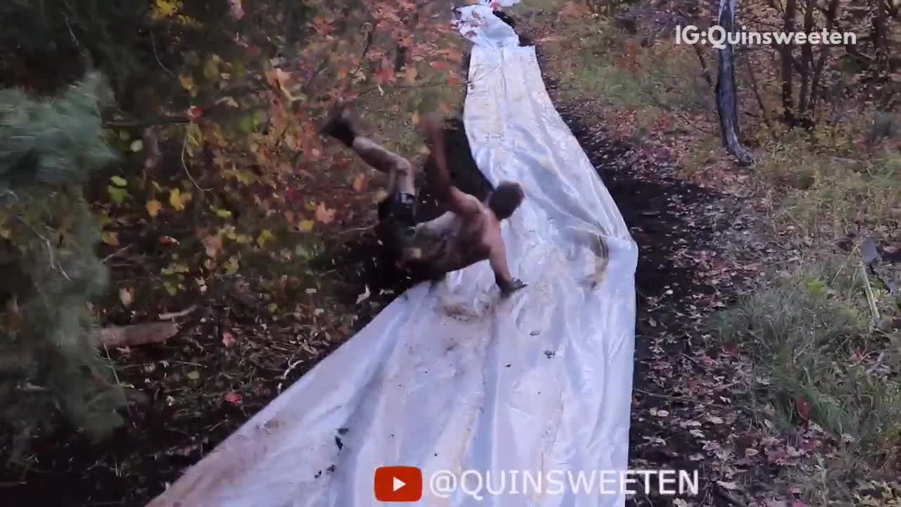 Shirtless man on makeshift mud slide