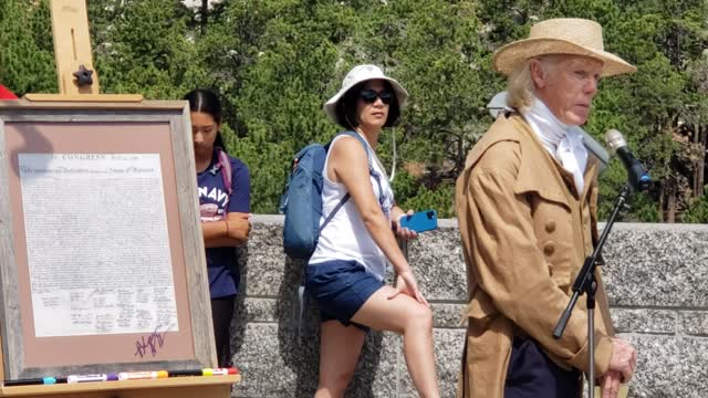 re-enactor Thomas Jefferson reads the preamble to the Declaration of Independence at Mt. Rushmore