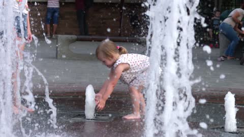 Cute little girl playing with water