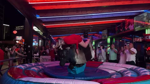 😱 OMG! Pretty Girl Fails at Mechanical Bull Ride in Benidorm | Spain 2024