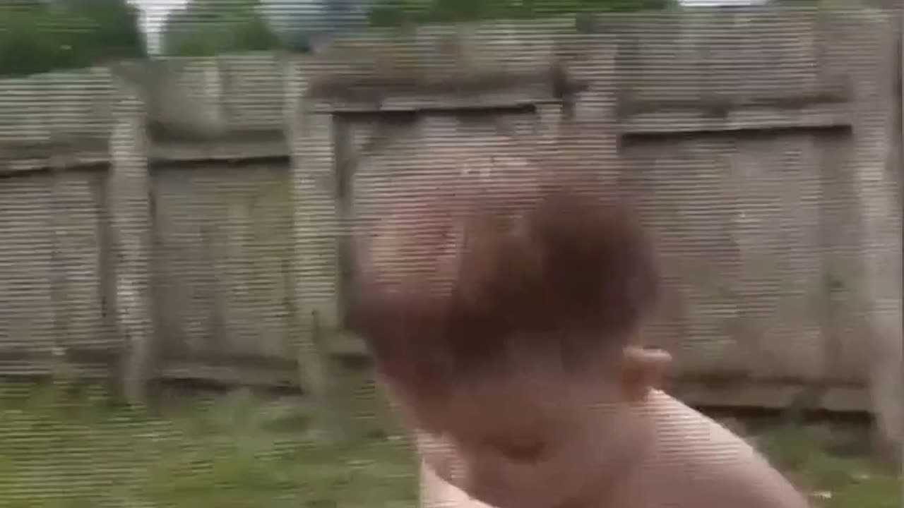 Baby playing in the rain