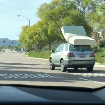Car suv driving with mattress bed on roof
