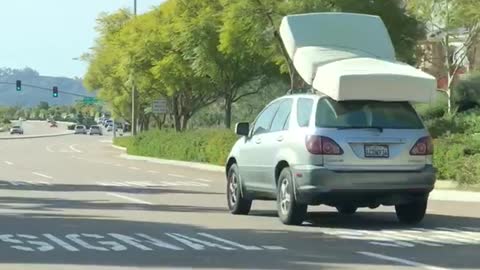 Car suv driving with mattress bed on roof