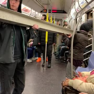 Pt. 2 guy carries gray metal beam inside subway train