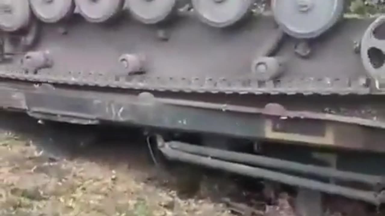 Ukrainian military engineering vehicle driving onto heavy-duty carrier falls off & ends upside down