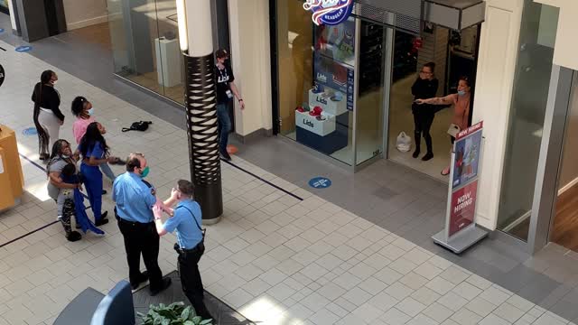 Man Casually Strolls Past Woman Pointing Gun Inside Mall