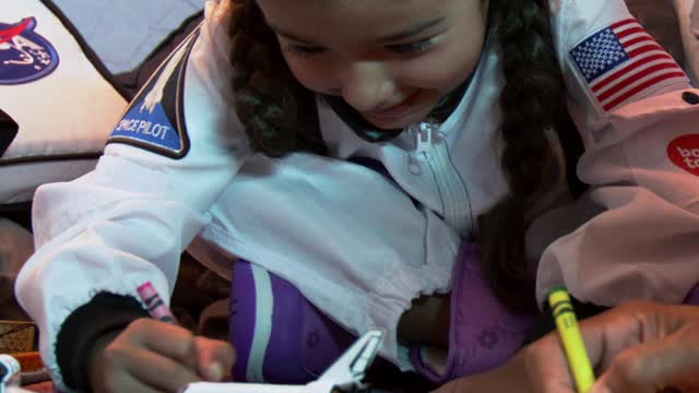 Little girl coloring with her father