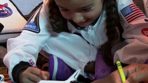 Little girl coloring with her father