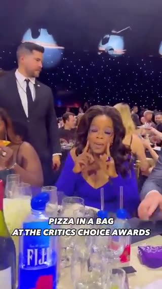 Oprah being served pizza in a bag at the Critics Choice Award show....