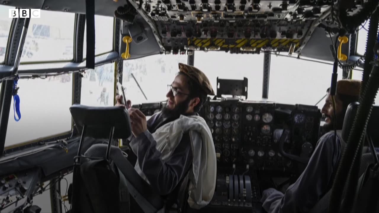 Taliban fighters pose in aircraft at Kabul airport
