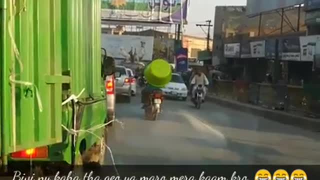 Pakistani man ride motorcycle with giant tub