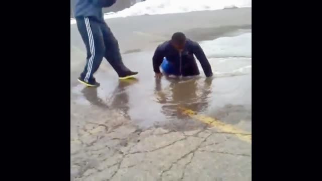 A friend jumps into a puddle