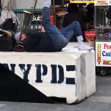 Man plays trumpet outside with his foot