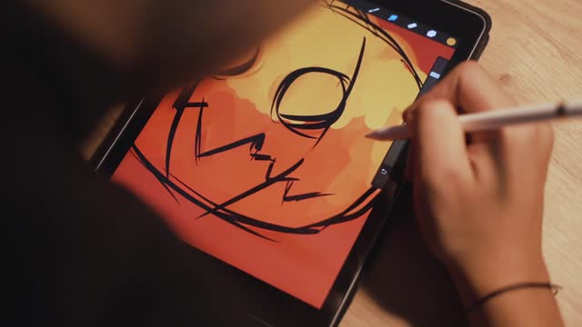 person drawing an artwork on the tablet