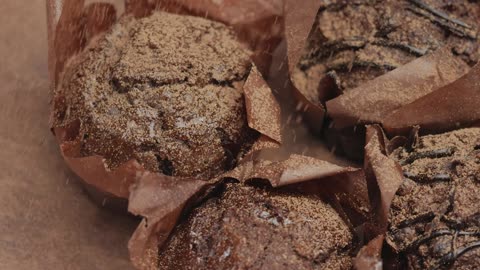 Sprinkle striped chocolate over chocolate cupcakes