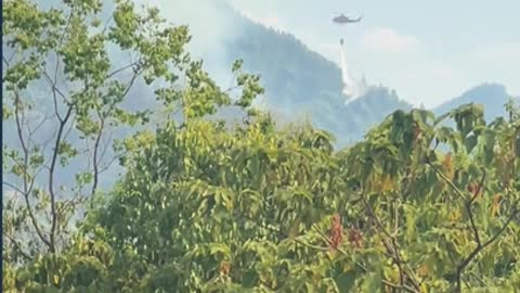 Helicopters engaged in the fire fighting in China's southwest city, Chongqing