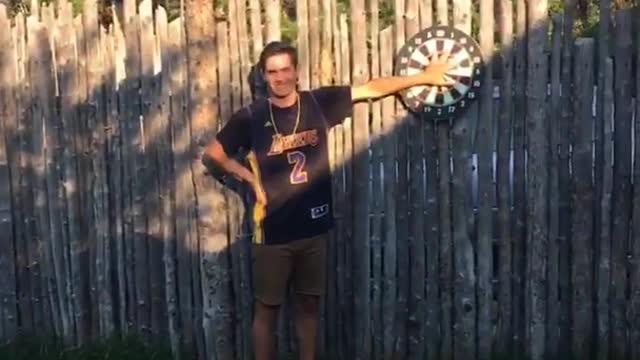 Helena dartboard barely misses hand