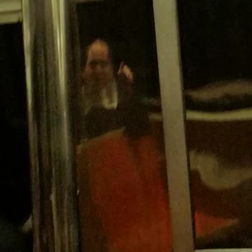 Man singing on train orange seats