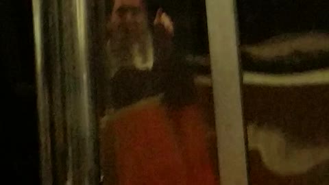 Man singing on train orange seats