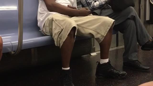 Guy white shirt khaki shorts falling asleep of grey plaid guy subway