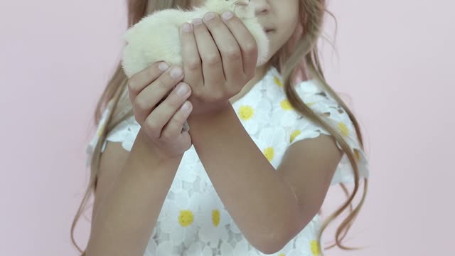 happy-cute-girl-holds-a-chicken-in-her-hands