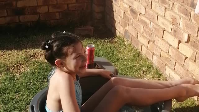 Funny - Child tries to take a dive in a small plastic tub.