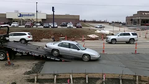 Sedan Gets Sunk in Wet Cement