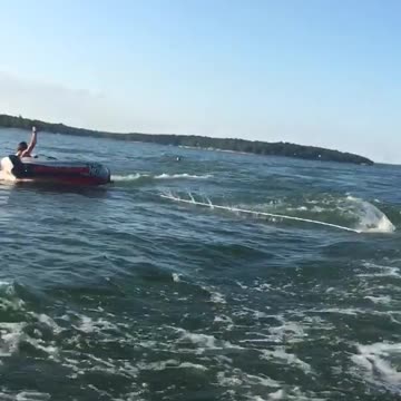 Three people raft boat lake one person falls off girl into water