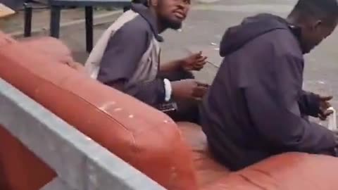 📍Ireland Two African men sit down to relax with a bag full of beers when they