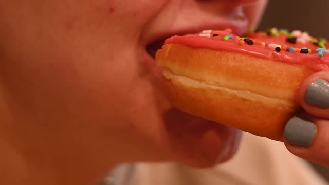 Woman Eating a Donut