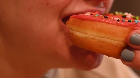 Woman Eating a Donut