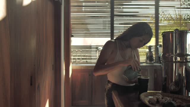 Woman prepares drink in a mug