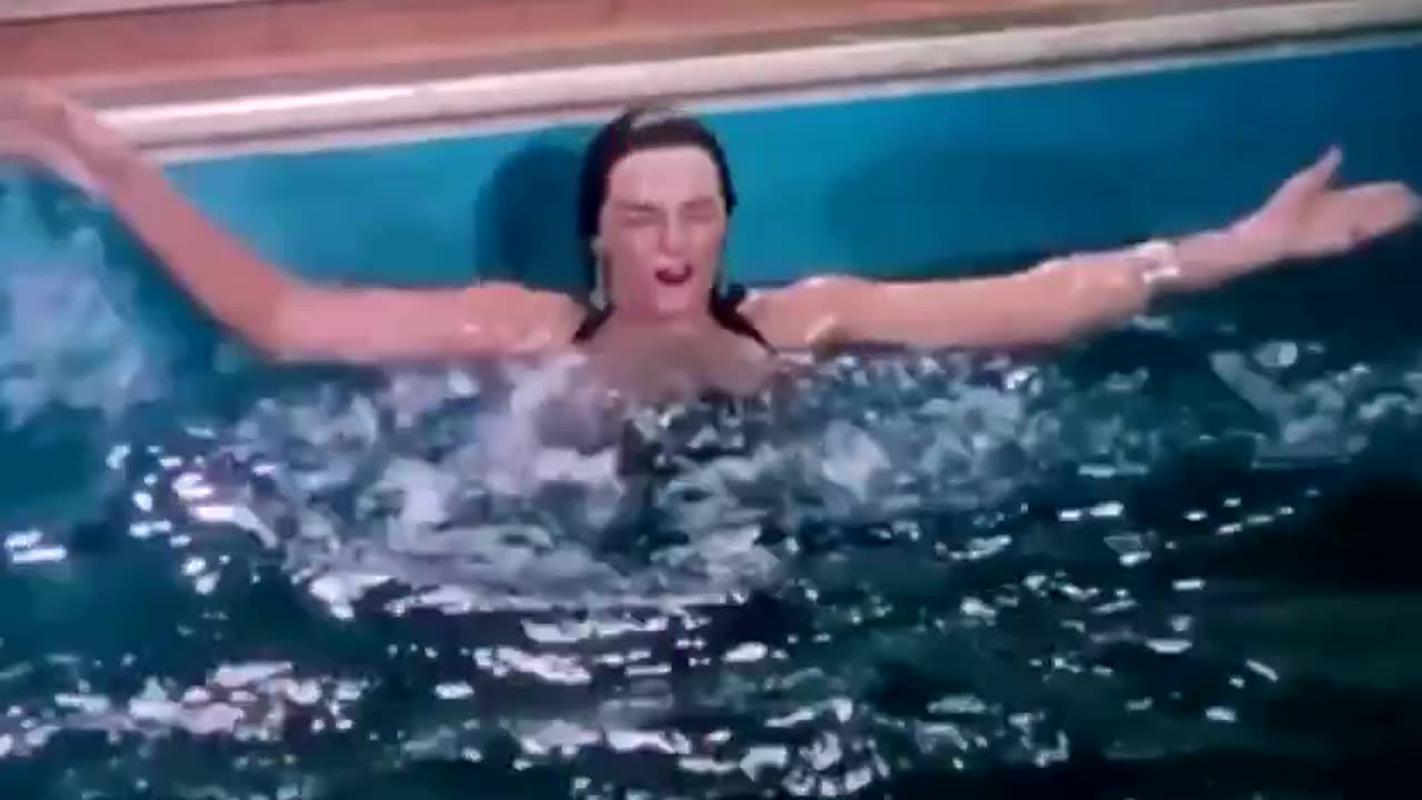 Actor Jane Russel getting accidentally knocked into pool by man diving over her