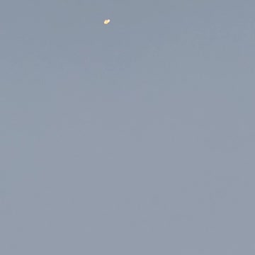 UFO flying past the full moon