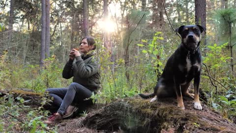 Woman and her dog in a forest