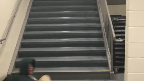 Guy front flip spin black jacket off of stairs hits floor