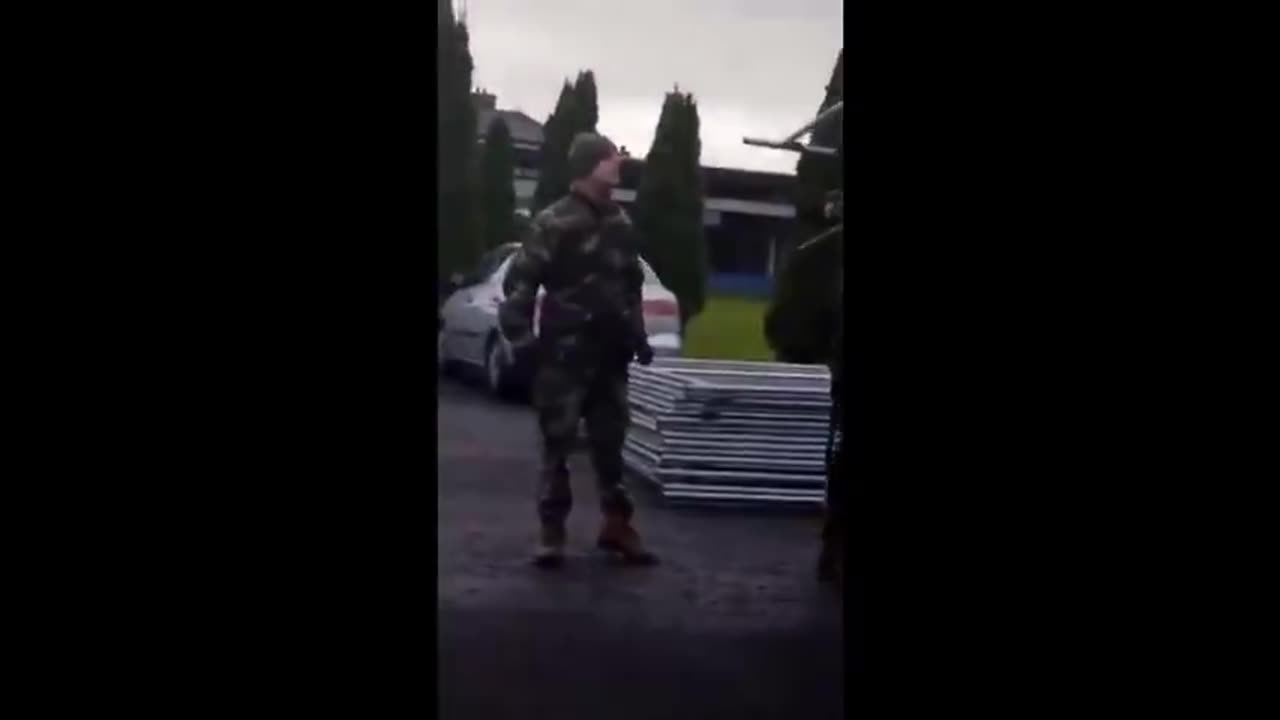 Irish woman confronts soldiers, who are under orders to help set up migrant camps