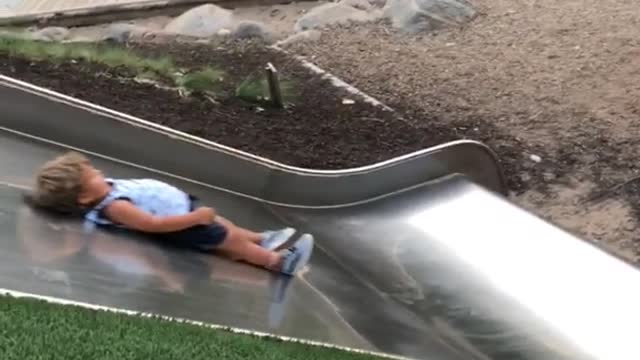 Three people down metal slide boy slow