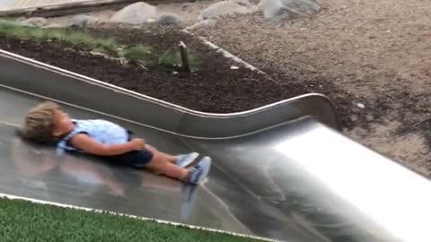 Three people down metal slide boy slow