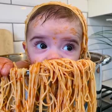 baby taking a pasta bath