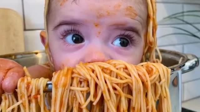 baby taking a pasta bath