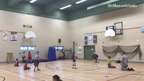 Man in grey throws dodgeball at kid in red