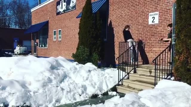 Brick building guy faceplant in snow