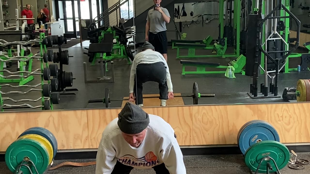 Old man cleaning 135 for three reps