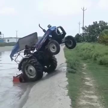 Tractor crossing the river against flow