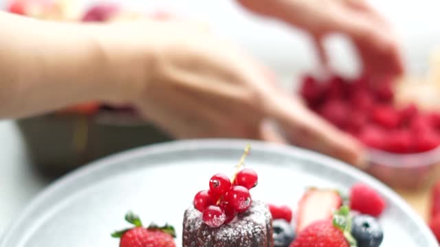 a-person-preparing-a-plate-of-dessert