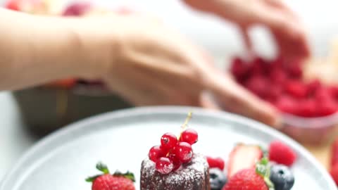 a-person-preparing-a-plate-of-dessert